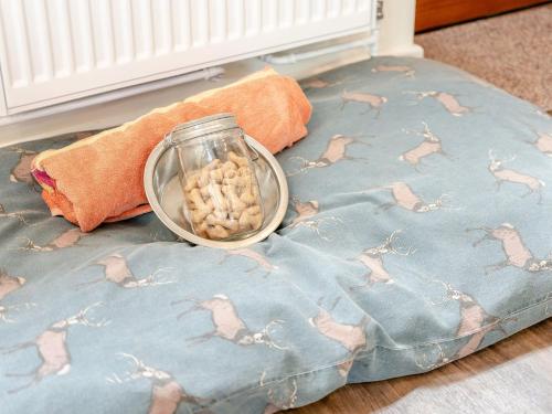 a bowl of peanuts sitting on top of a pillow at 2 Bed in Godshill 96127 in Godshill