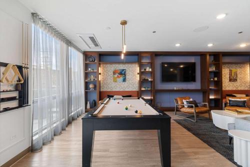 a living room with a pool table in it at 2BR City Loft Amazing Glass Views in Chicago