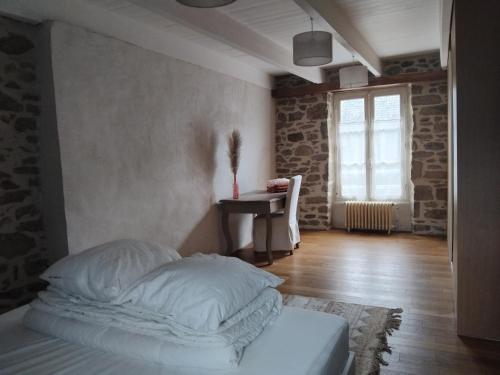 a bedroom with a bed and a desk and a window at Spacious 3 bedroom house 250m from Saint-Suliac's beach in Saint-Suliac