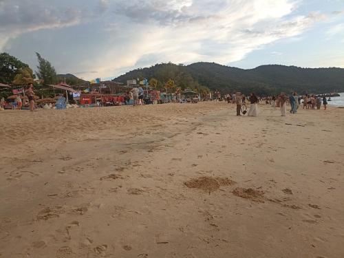 a group of people walking on the beach at Sri sayang pearl view in Batu Ferringhi