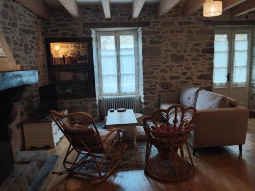 a living room with a couch and chairs and a table at Spacious 3 bedroom house 250m from Saint-Suliac's beach in Saint-Suliac