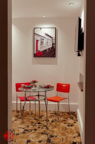 a dining room with a table and red chairs at New Alhussien Hotel in Asyut