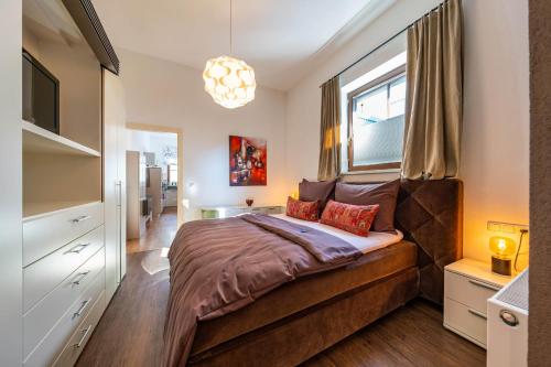 a bedroom with a large bed and a window at Appartements Mair in Mayrhofen