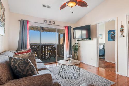 a living room with a couch and a table at Baywatch A10 in Pensacola Beach
