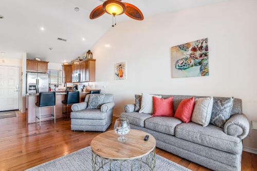 a living room with a couch and a table at Baywatch A10 in Pensacola Beach