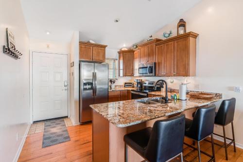 a kitchen with a large island with bar stools at Baywatch A10 in Pensacola Beach