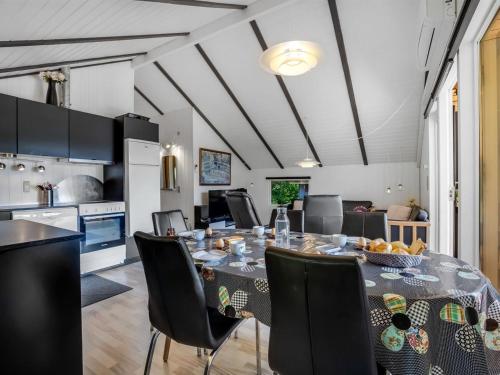 a kitchen and dining room with a table and chairs at Holiday Home Yarla - 500m to the fjord by Interhome in Vemb
