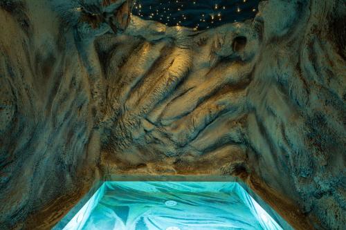 a cave with a pool of water in it at Pousadela Village & Spa in Vieira do Minho