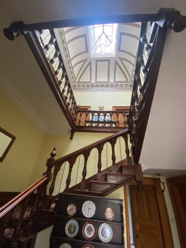 a spiral staircase with clocks on the sides of it at Bellfield Country Suites in Masham