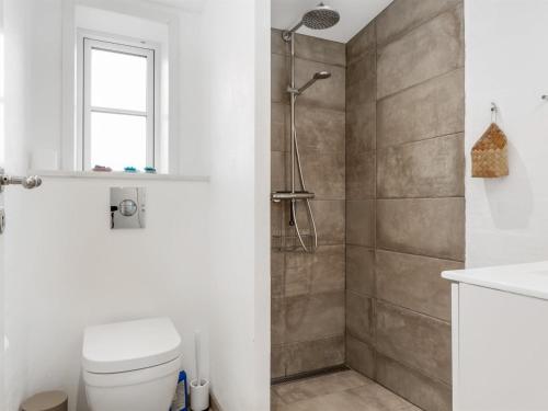 a bathroom with a shower and a toilet and a sink at Holiday Home Nanja - 250m from the sea by Interhome in Læsø