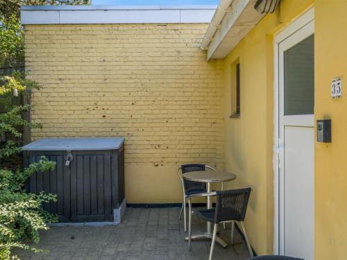 a patio with chairs and a table next to a building at Apartment Didrik - 2km from the sea by Interhome in Skagen