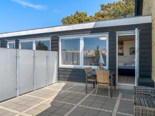 a patio of a house with a table and chairs at Apartment Didrik - 2km from the sea by Interhome in Skagen