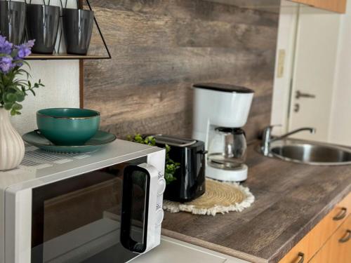 a kitchen counter with a coffee maker and a microwave at Fährhaus Brunsbüttel in Brunsbüttel