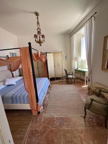 a bedroom with a bed and a chandelier at Casa di Candida in Amantea