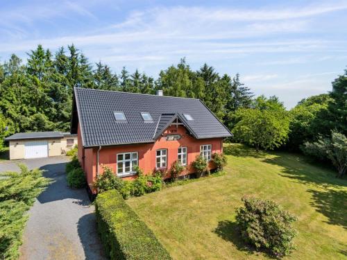a red house with a large yard at Holiday Home Marit - 1-5km from the sea by Interhome in Neksø