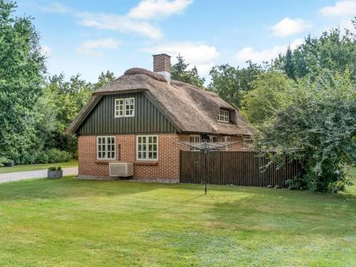 an old brick house with a thatched roof at Holiday Home Hilaria - 2-1km from the sea by Interhome in Aså