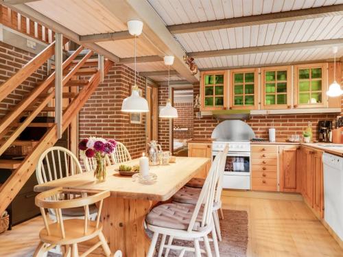 a kitchen with a wooden table and chairs at Holiday Home Hilaria - 2-1km from the sea by Interhome in Aså