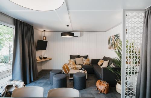 a living room with a couch and chairs at Village Collection Le Vauvert in Ormoy-la-Rivière