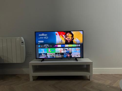 a flat screen tv sitting on top of a table at The Loft in Merthyr Tydfil