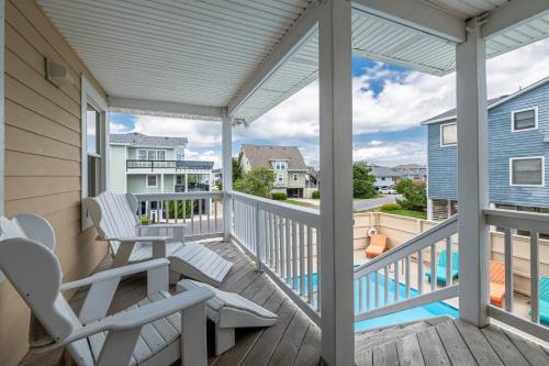 a balcony with chairs and a view of a pool at Patriots Place- C1776 in Poplar Branch