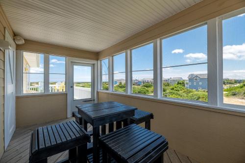 a porch with two benches and windows with a view at Patriots Place- C1776 in Poplar Branch