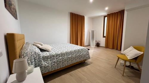 a bedroom with a bed and a table and a chair at La Vigna 1803 in Casa Gagliano