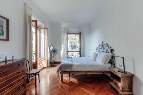 a bedroom with a bed and a wooden floor at Almost Paradise by Quokka 360 - flat with a view of Lake Como in Brunate
