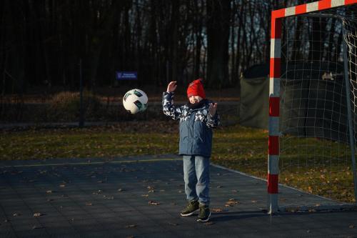 a young boy is playing with a soccer ball at Moje Miejsce Kazimierz in Kazimierz Dolny
