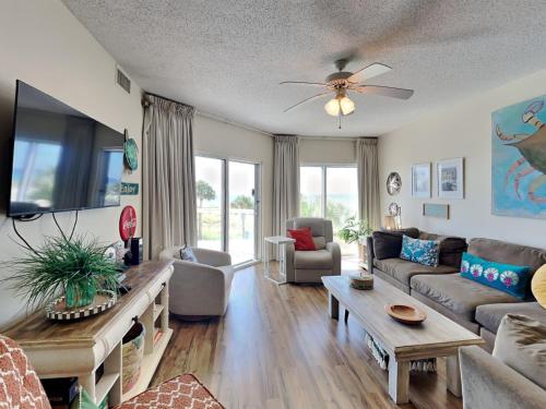 a living room with a couch and a table at Emerald Isle #106 in Pensacola Beach