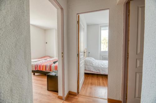 an open doorway to a bedroom with a bed at Logis Belledonne in Arvillard