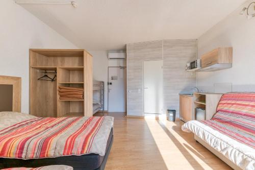 a bedroom with two beds in a room at Logis Belledonne in Arvillard