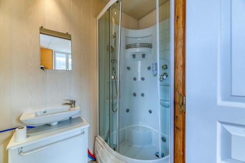 a bathroom with a shower and a sink at Logis Belledonne in Arvillard