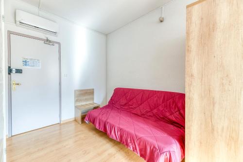 a bedroom with a red bed in a white room at Logis Belledonne in Arvillard