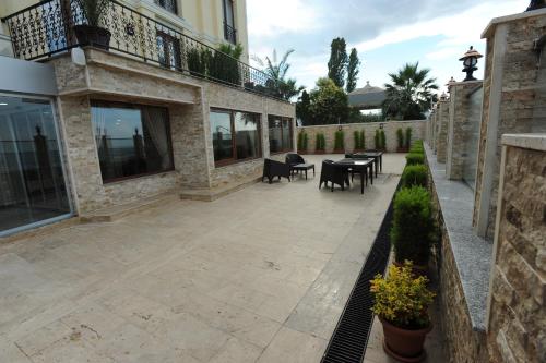 a patio with tables and chairs next to a building at Vurna Butik Hotel in Trabzon