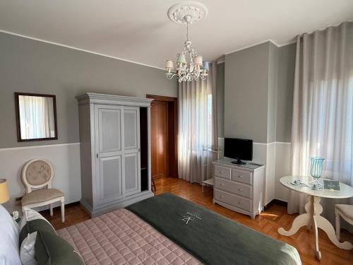 a bedroom with a bed and a table and a television at Villa Zane in Treviso