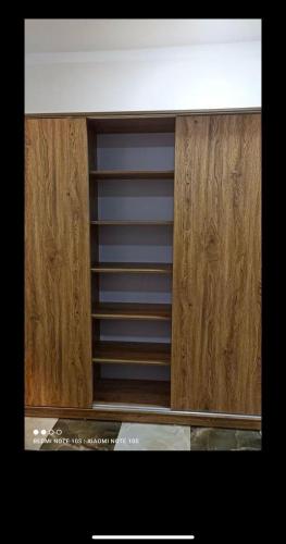 a wooden cabinet with a shelf in a kitchen at Dream Apartment 4 in Hurghada