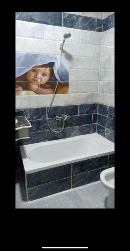 a bathroom with a picture of a person under a shower at Dream Apartment 4 in Hurghada