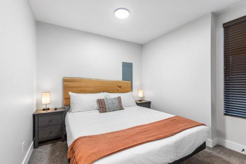 a bedroom with a large bed and two night stands at Beach Suites in Parksville
