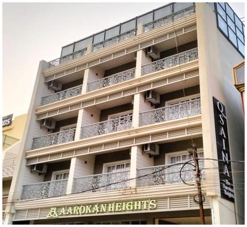 an apartment building with balconies on the side of it at Hotel Q Saina Aarokan Height Near Sea Beach And Jagannath Temple Puri in Puri