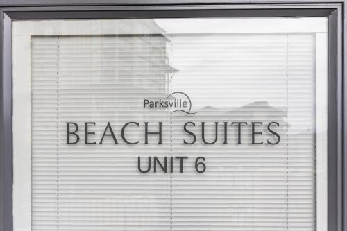 a window with the words beach suites unit at Beach Suites in Parksville