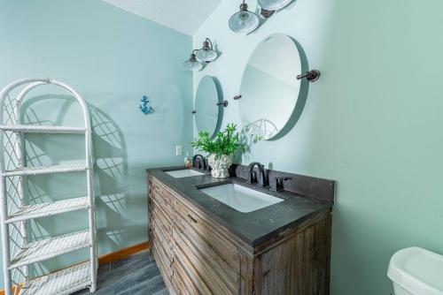 a bathroom with a sink and a mirror at Pier Pleasure in Whalebone