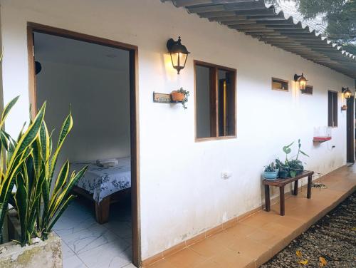 a door to a house with a table and a bench at Hermoso Palomino in Palomino