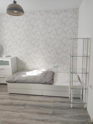 a bedroom with a bed and a glass shelf at 64747 Breuberg Odenwald 2 Schlafzimmer in Breuberg