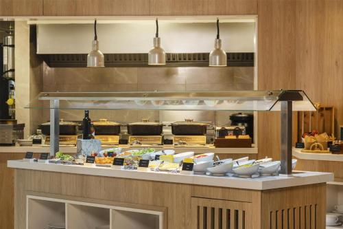 a food counter in a restaurant with plates of food at Radisson Hotel Tunis, City Center in Tunis