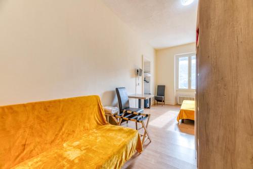 a bedroom with a bed and a desk in a room at Logis Belledonne in Arvillard