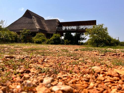 a building with a pile of rocks in front of it at Tabingi Safari Lodge in Katunguru