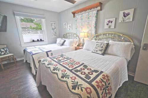 a bedroom with two beds and a window at Double Double in Bed & Breakfast - And a Hot Tub! in Frankenmuth