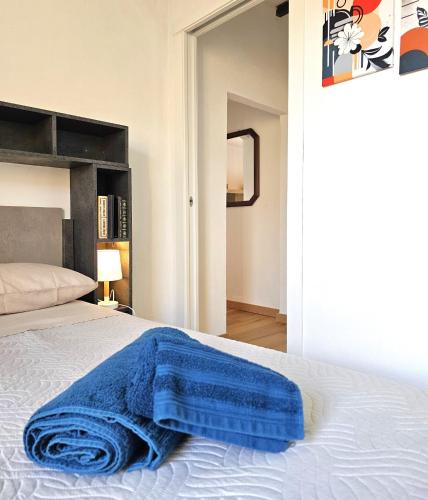 a blue blanket laying on a bed in a bedroom at Casa Olivazzo in Chiusi