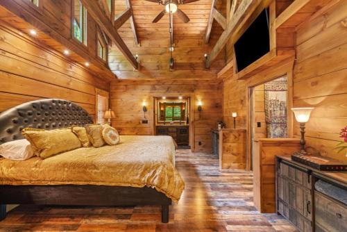 a bedroom with a bed in a room with wooden walls at The Lake Cabin in Santaluca
