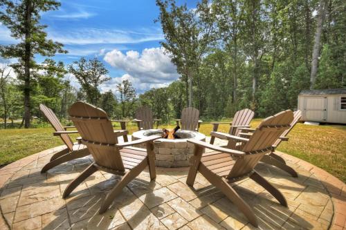 a patio with four chairs and a table and a fire pit at Georgia Peace Chalet in New Hope